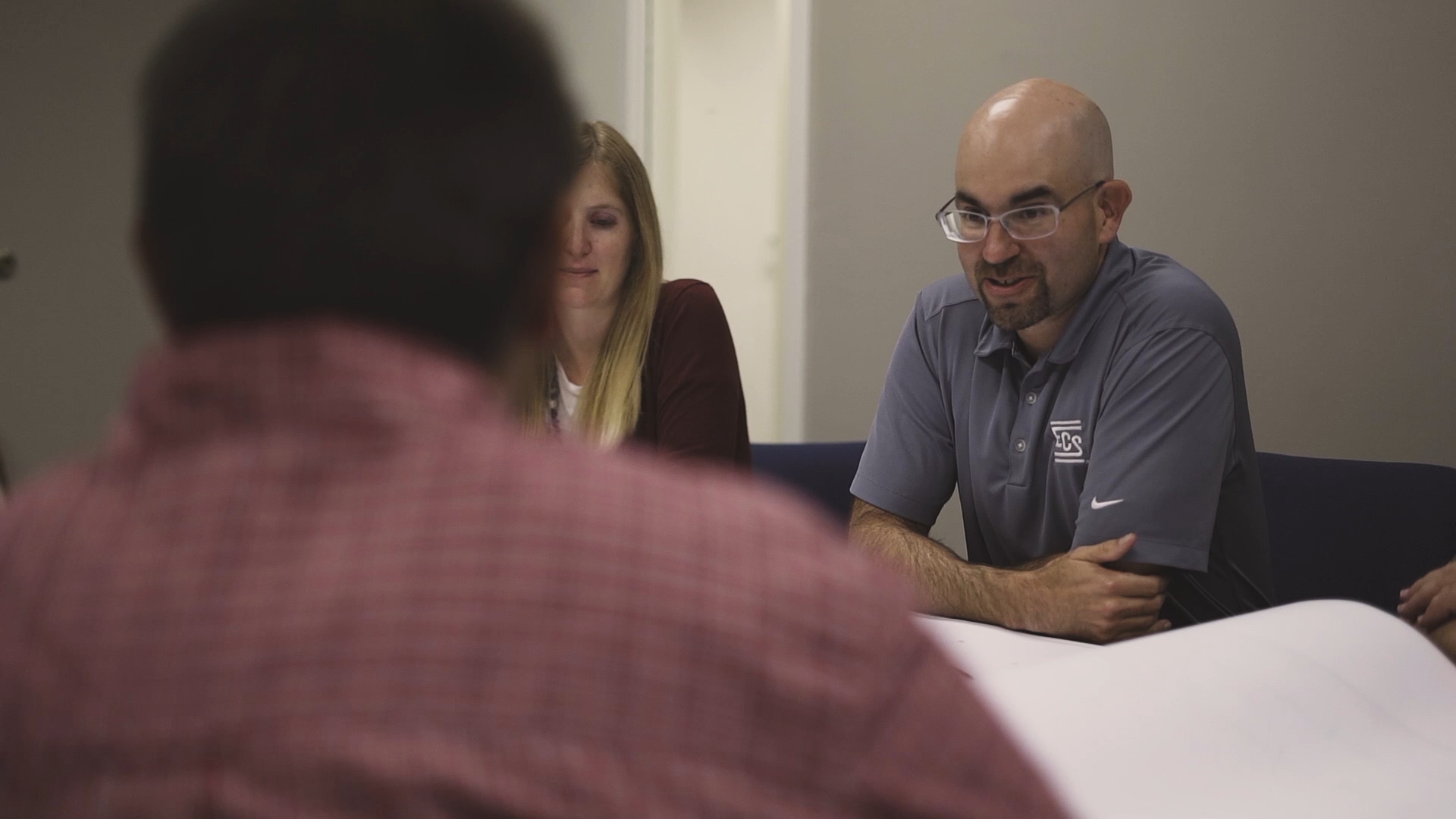 ECS team talking in conference room