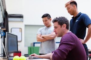 three engineers looking at test results