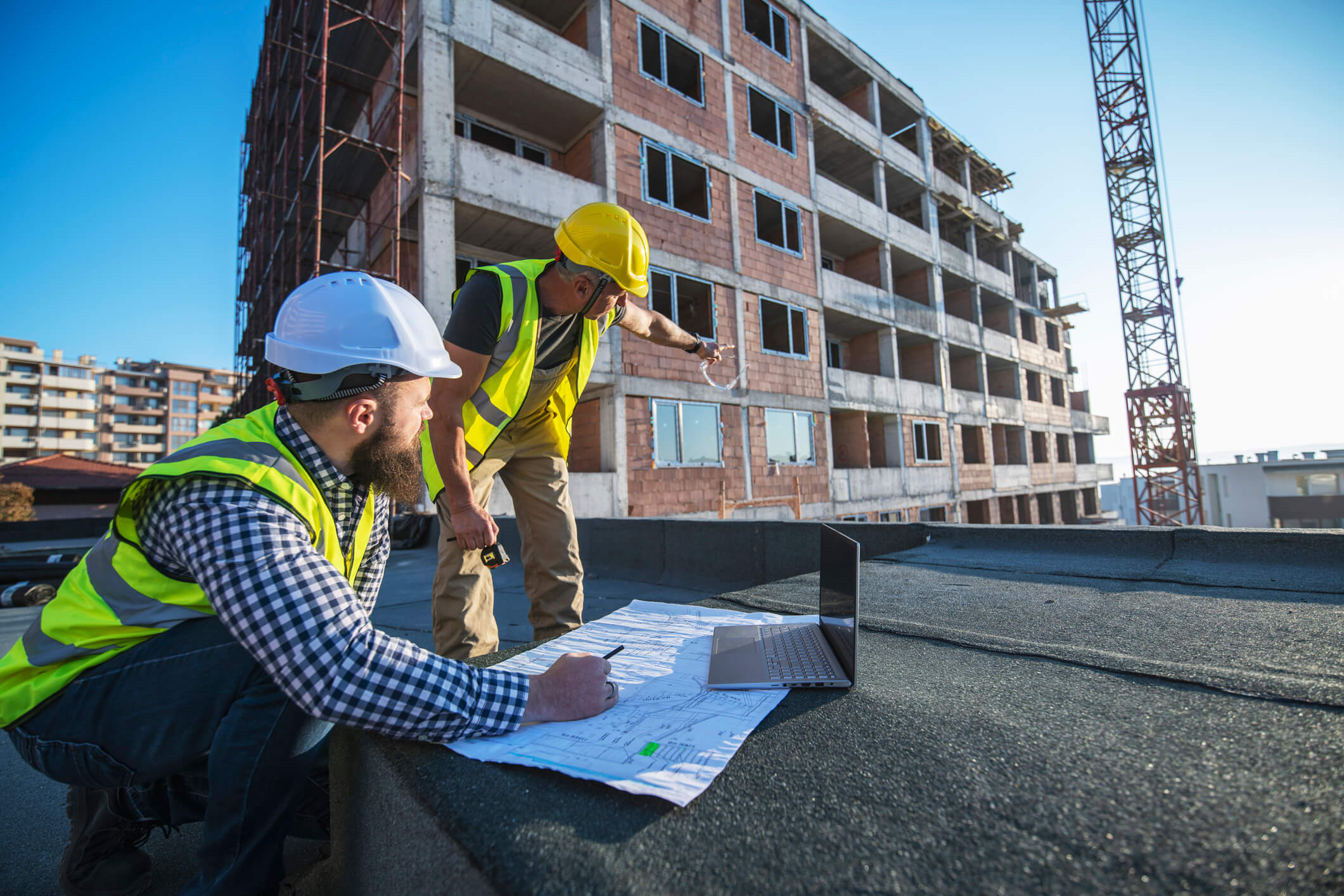 two engineers reviewing construction plans