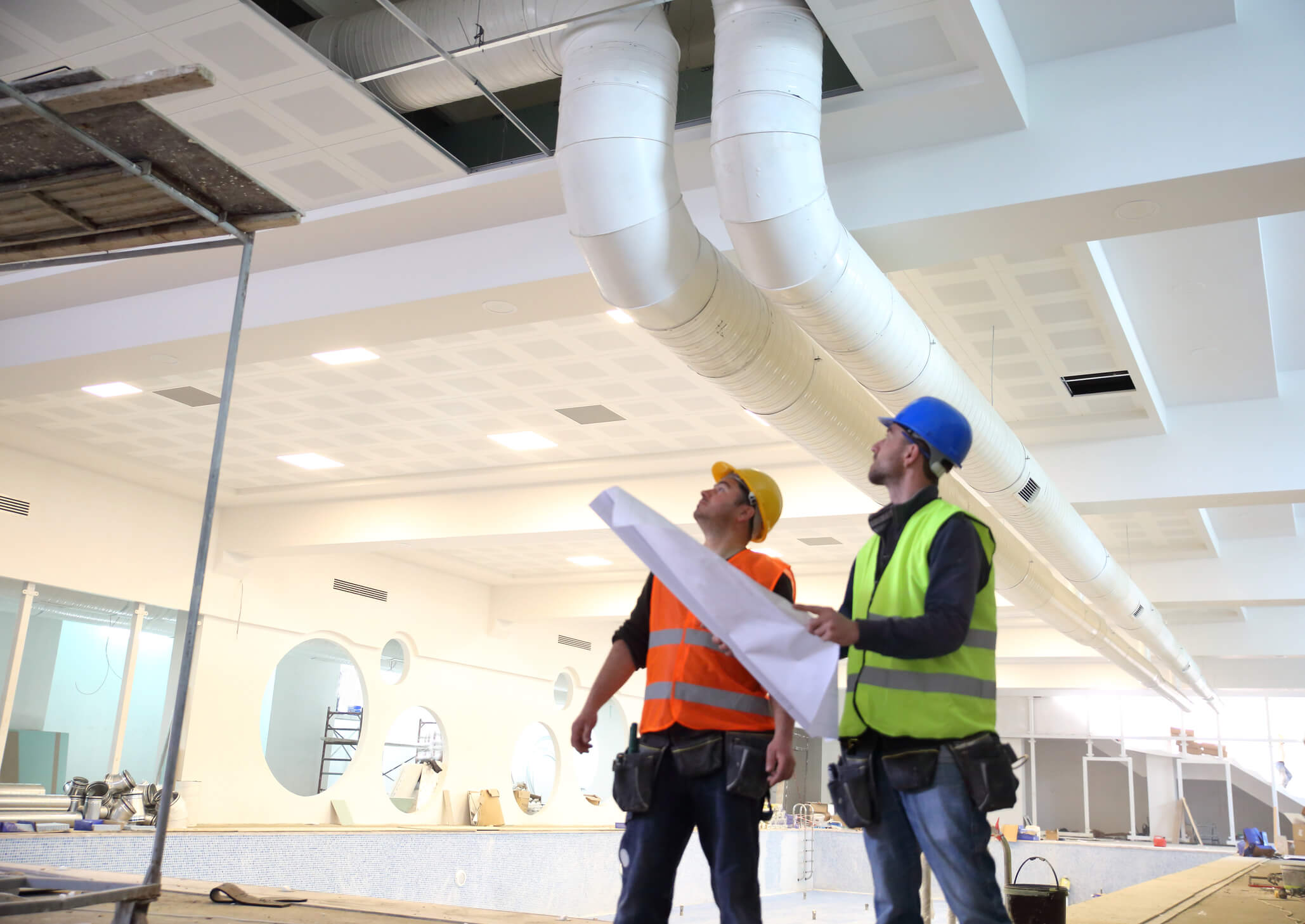 two engineers looking up at ceiling