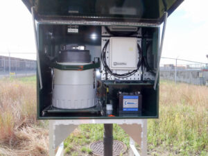 Closeup of metal box housing a composite sampler, wires and other equipment used for stormwater pollution prevention planning.