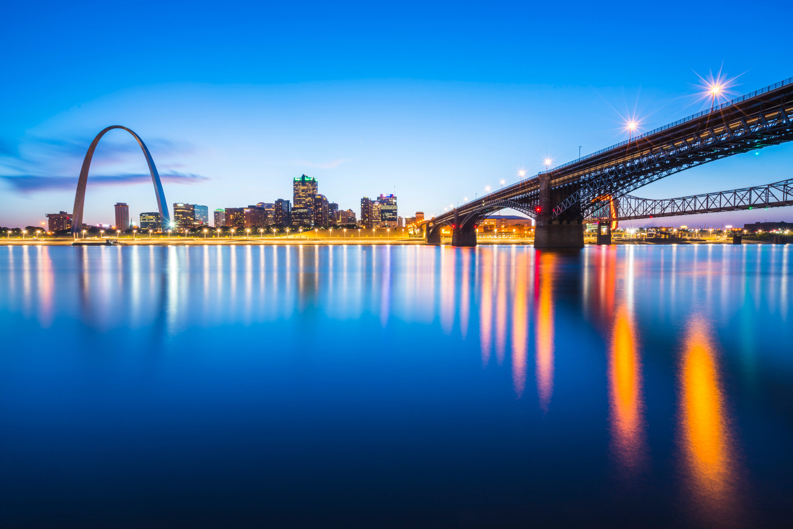 St.,Louis,Skyscraper,At,Night,With,Reflection,In,River,st.,Louis,missouri,usa.