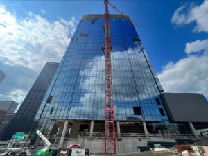 Photo of a building enclosure design project from the ground looking up the glass facade of a skyscraper.