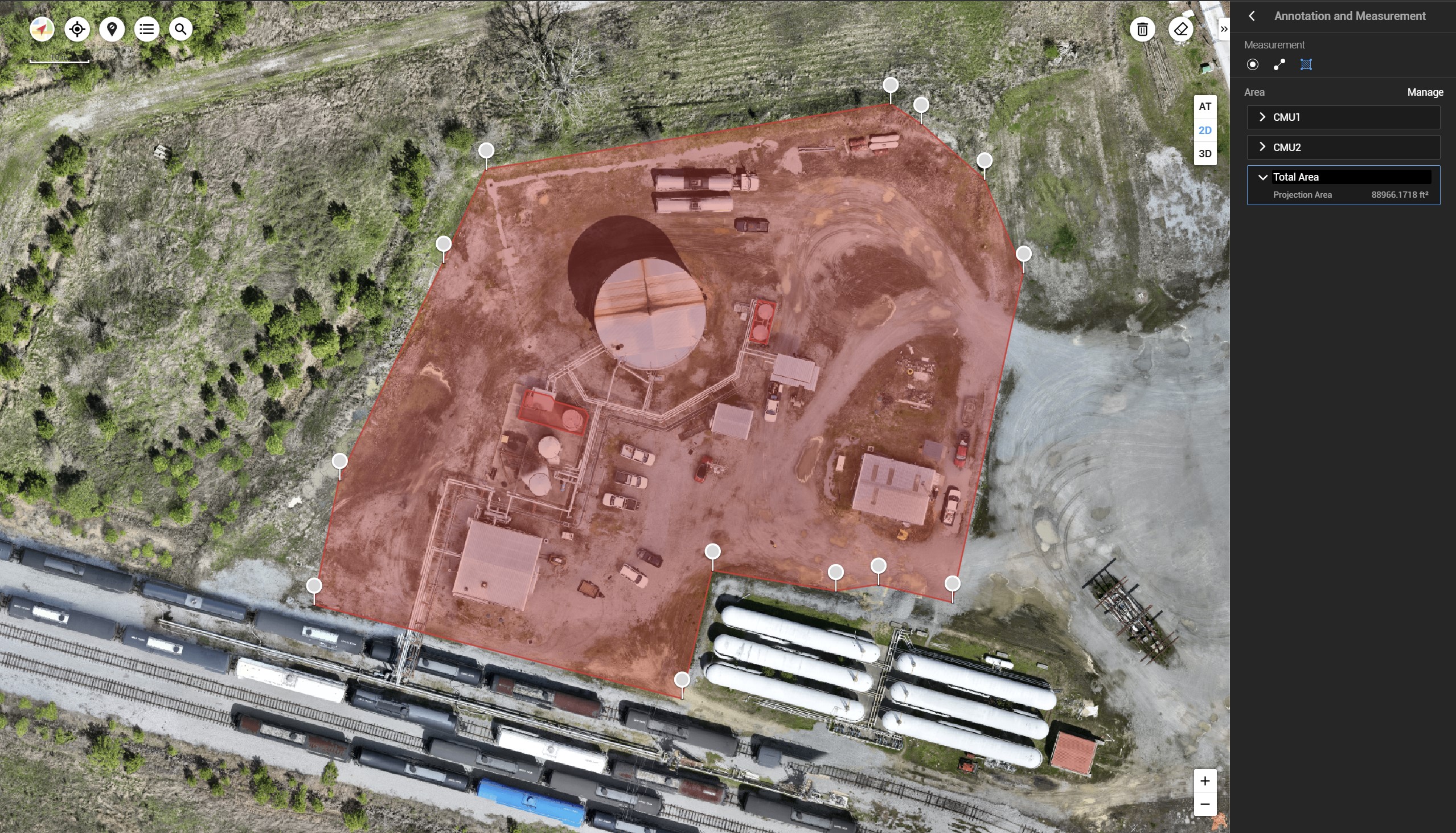 Aerial view of an industrial site with equipment, vehicles, and structures, digitally marked and measured for area analysis using unmanned aircraft system services. The outlined region is highlighted in red, showing a total projection area of 88,966.1718 square feet.